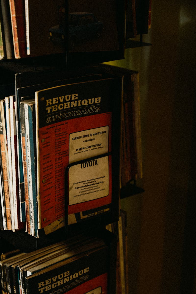 A collection of vintage car repair manuals on display, showcasing automotive history.